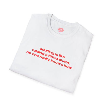 "Adulting Is Like Folding A Fitted Sheet, No One Really Knows How." | Text Only | T-Shirt