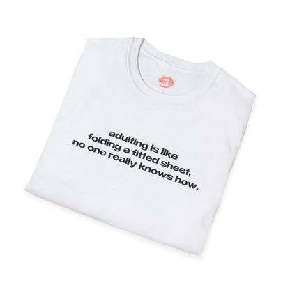 "Adulting Is Like Folding A Fitted Sheet, No One Really Knows How." | Text Only | T-Shirt