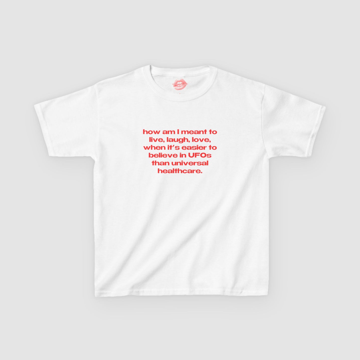 "How Am I Meant To Live, Laugh, Love, When It's Easier To Believe In UFOs Than Universal Healthcare." | Text Only | Baby Tee